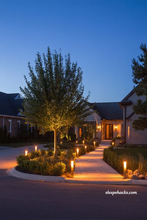 front yard landscaping ideas with landscape lighting night curb appeal path lights uplighting and warm glowing entry design