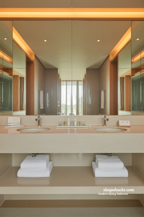 hotel inspired modern luxury bathroom with soft lighting thick towels and minimalist spa style suite interior design 