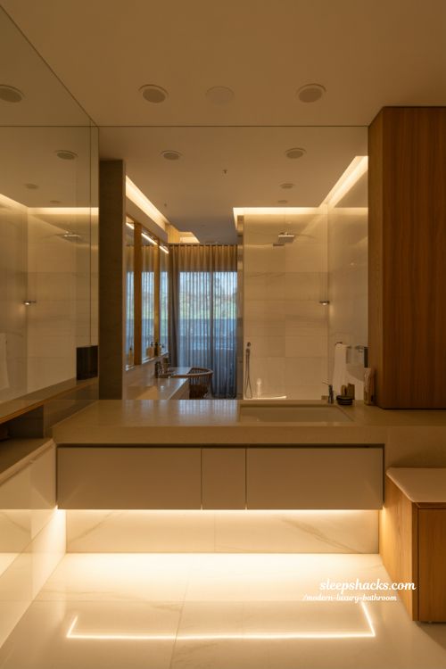 lighting design in modern luxury bathroom with layered ambient LEDs backlit mirrors and warm spa inspired atmosphere 