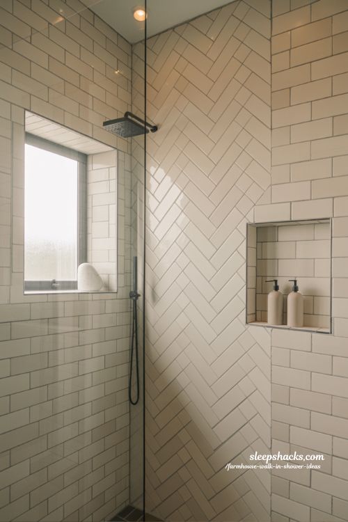 modern farmhouse walk in shower with herringbone tile pattern and clean spa style bathroom design