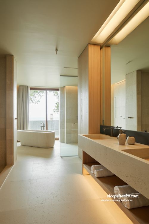 modern luxury bathroom spa retreat with minimalist stone design freestanding tub and warm ambient lighting 