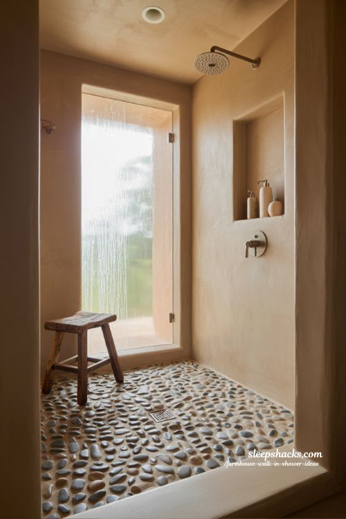 rustic walk in shower with pebble stone floor and natural stone walls farmhouse spa bathroom design