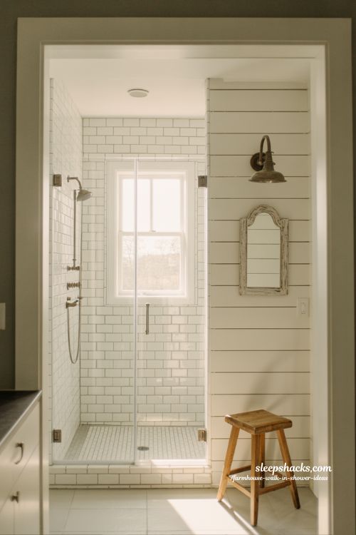 shiplap accent wall behind glass walk in shower farmhouse bathroom with white rustic country style design