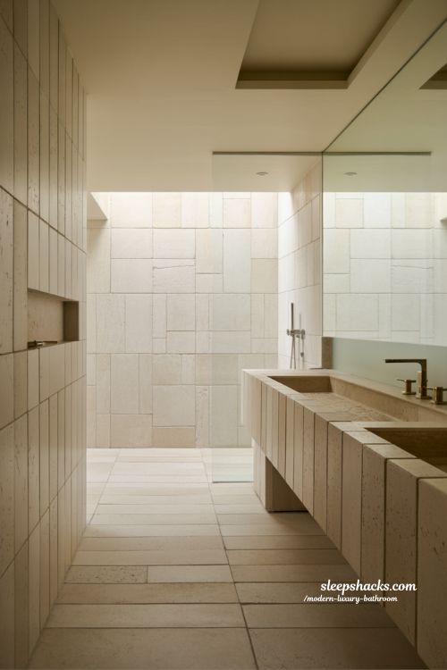 tile design in modern luxury bathroom with large format stone tiles mosaic accents and calm spa inspired minimalist interior 