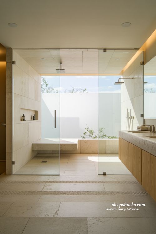 walk-in shower modern luxury bathroom design with frameless glass rainfall shower stone interior and spa inspired minimal style 