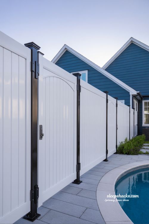 white vinyl privacy fence ideas with black metal accents for a modern elegant poolside backyard design