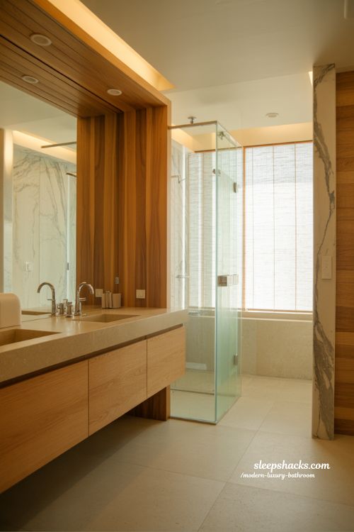 wood accent modern luxury bathroom with warm oak vanity stone textures soft lighting and spa inspired natural interior design 