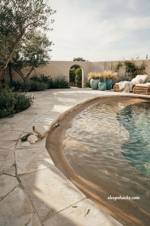 Beach entry pool ideas with a gentle zero entry slope like an ocean shore