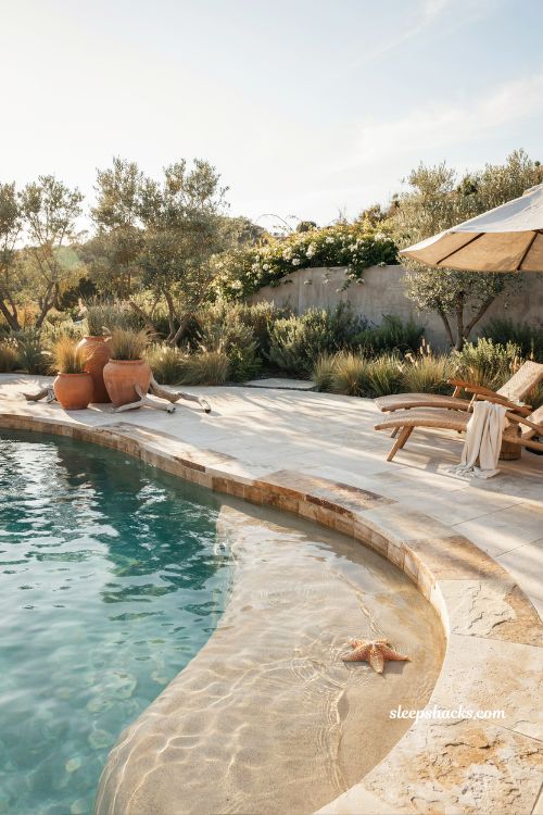 Beach entry pool ideas with a luxurious coastal resort style backyard