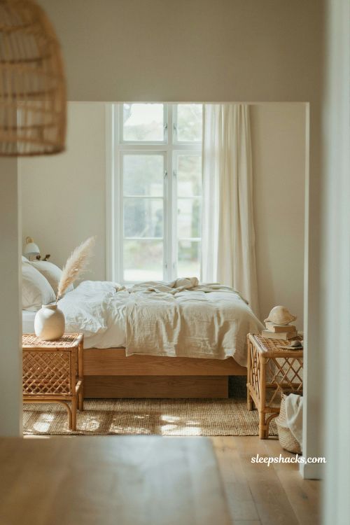 Beach house bedroom with rattan nightstands and light wood bed coastal organic woven furniture natural airy minimalist interior design