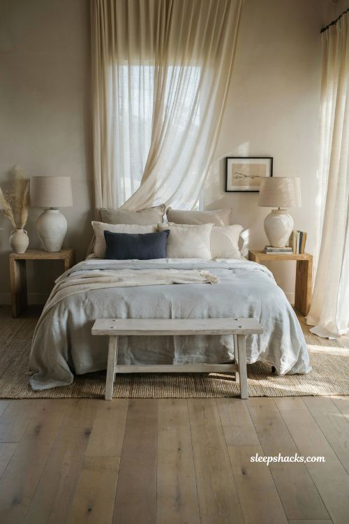 Beach house bedroom with soft linen bedding and morning coastal light