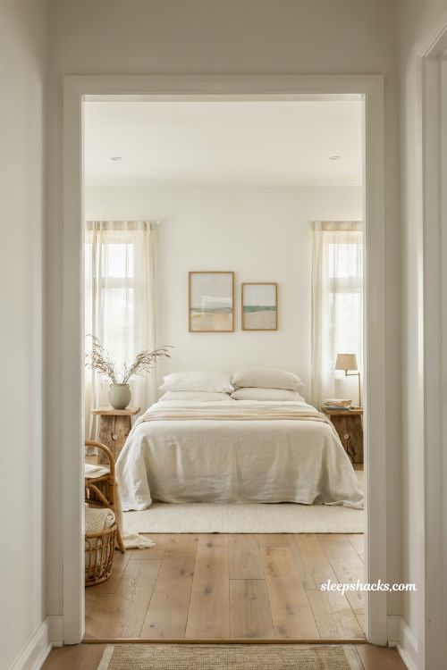 Beach house bedroom with white walls calm coastal minimalist interior soft natural light airy serene seaside design