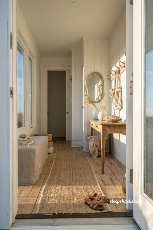 Beach house entryway ideas with sun bleached wood console and sea glass blue walls