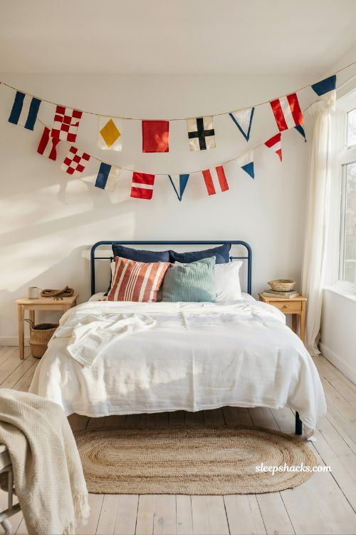 Beach room aesthetic bedroom with maritime flags wall art and navy coastal decor for kids or teen room