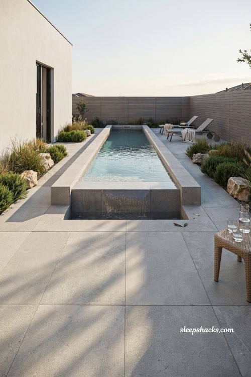 Classic rectangular lap pool backyard inground idea with modern spa and concrete pavers