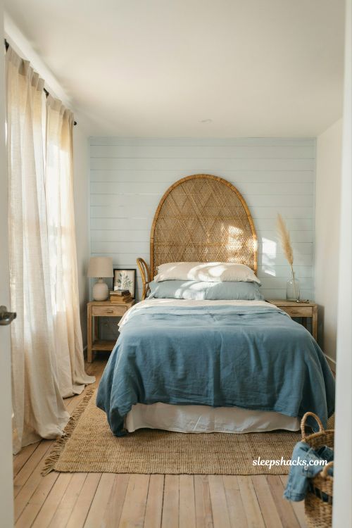 Coastal blue bedroom ideas with rattan headboard and relaxed beach cottage texture