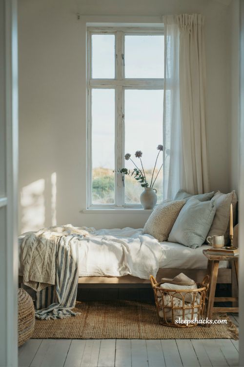 Coastal cottage living room ideas with cozy window daybed and relaxed coastal afternoon aesthetic