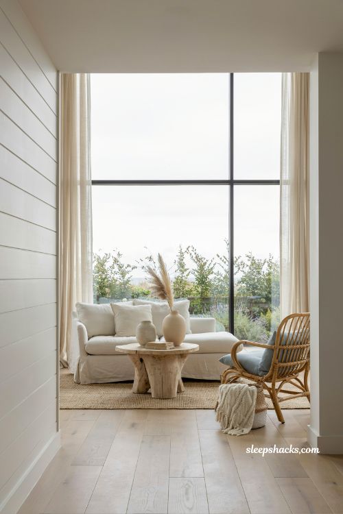 Coastal cottage living room ideas with large bare windows and natural light filled coastal interior