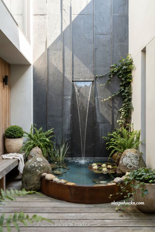 Container pond ideas with a modern slate water wall for a courtyard patio 