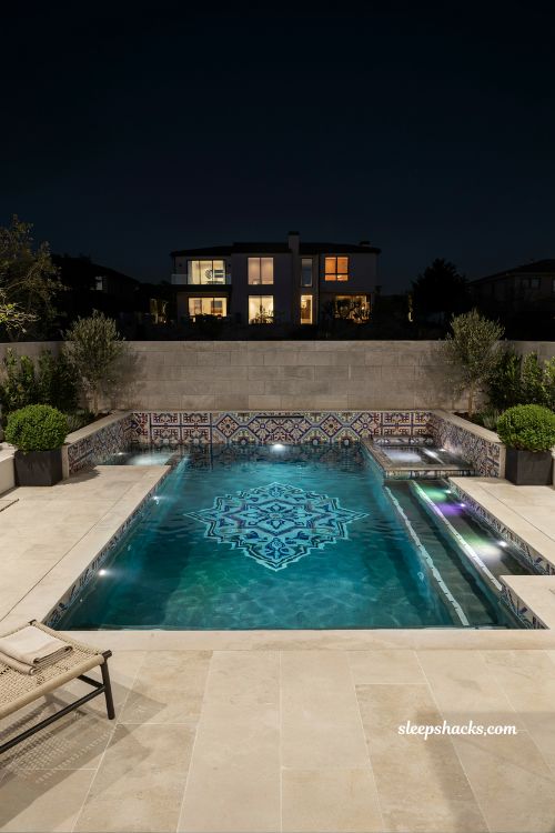 Custom mosaic tile pool with LED lighting luxury backyard design modern inground pool with artistic tile work and colorful nighttime illumination