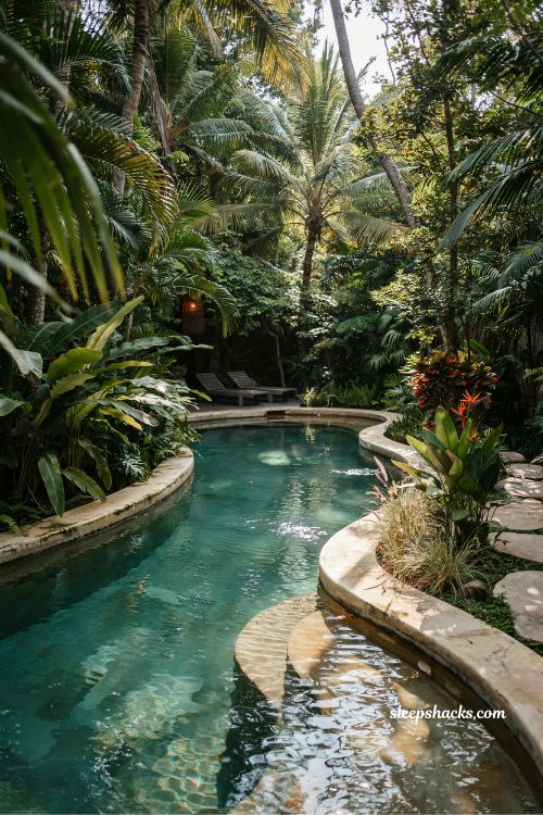 Freeform pool with tropical landscaping and natural lagoon style design