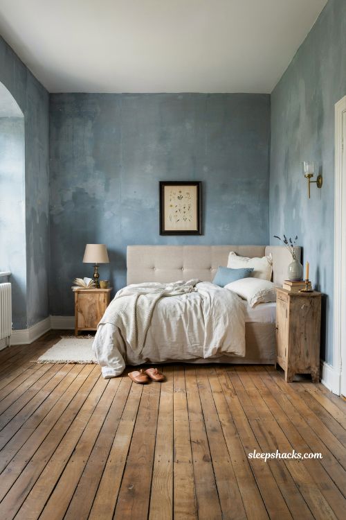 French blue bedroom ideas with linen bedding rustic wood floors and vintage brass accents