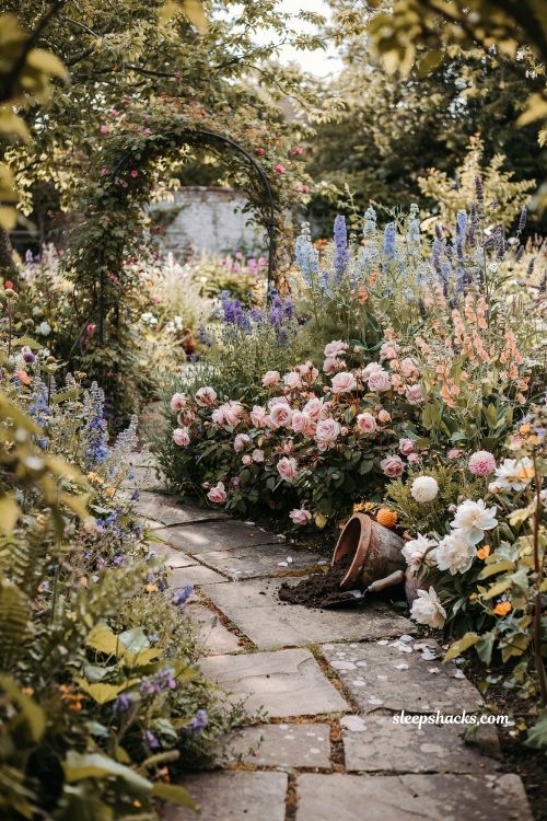 Garden fairytale ideas with overgrown cottage flower beds in soft pastel blooms