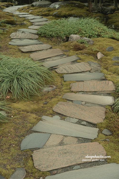 Japanese garden stepping stone path with moss edges and natural granite walkway through tranquil courtyard landscape
