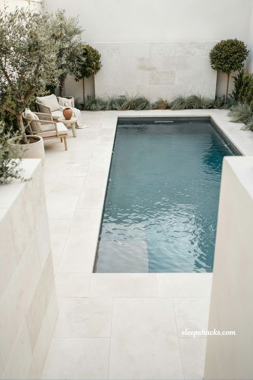 Light toned decking modern small pool design that makes compact backyard feel bigger