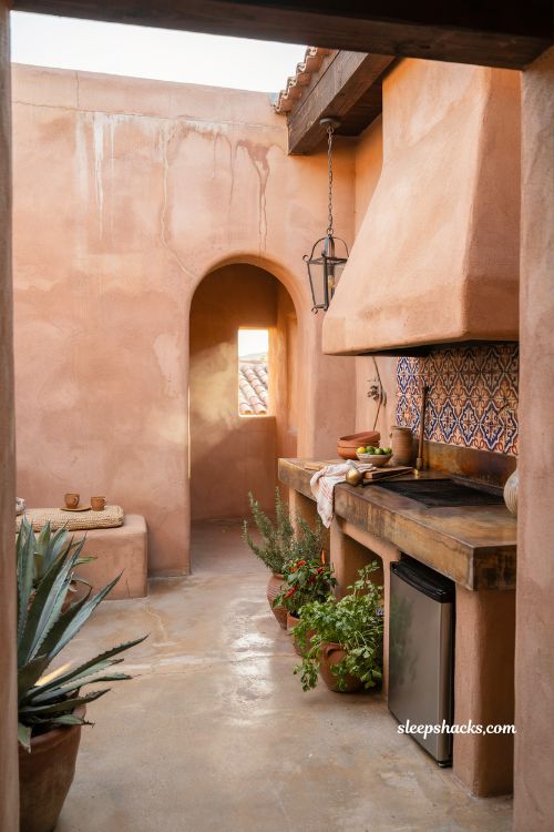 Mexican hacienda patio ideas with compact outdoor kitchen grill and rustic tiled backsplash