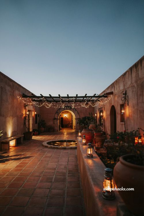 Mexican hacienda patio ideas with solar lanterns and warm string lights outdoor evening lighting