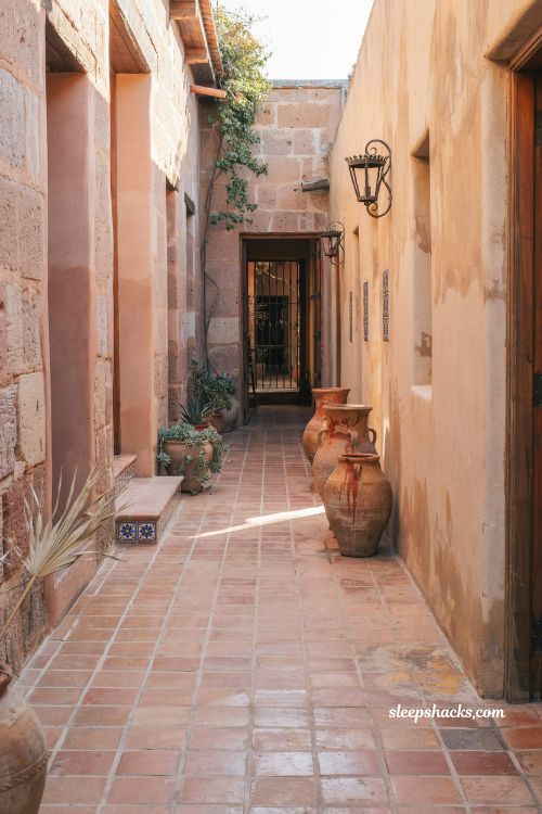 Mexican hacienda patio ideas with terracotta urn clusters and adobe walls outdoor decor