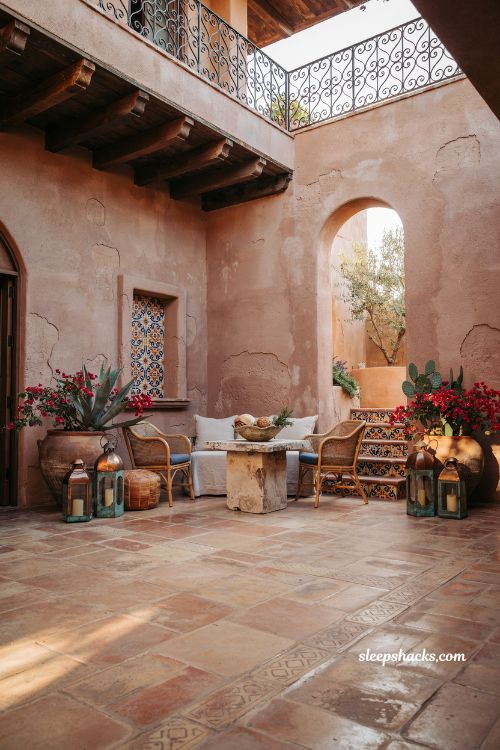 Mexican hacienda patio ideas with terracotta walls hand painted tiles and copper lantern decor