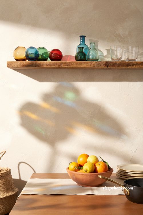 Mexican home decor ideas blown glass decorative objects jalisco artisan glassware colorful kitchen shelf styling natural light decor