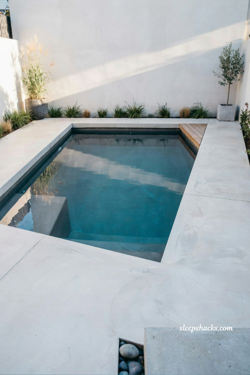 Minimalist backyard plunge pool for small yard with clean modern concrete design and compact luxury urban outdoor living aesthetic