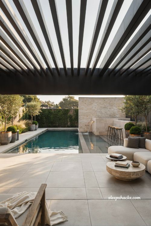 Modern pool with built in spa and elegant raised spillway design for backyard living