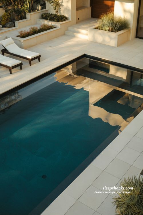 Modern rectangle pool with dark bottom liner and lagoon style water effect design ideas