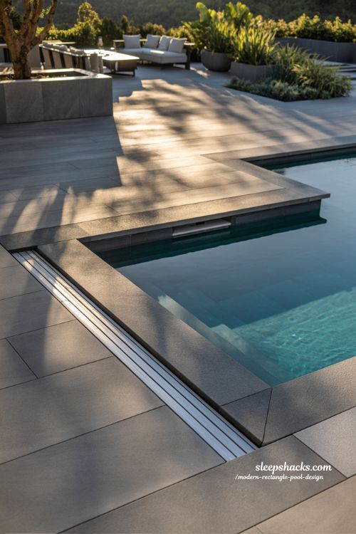 Modern rectangle pool with hidden automatic retractable cover and seamless deck design ideas