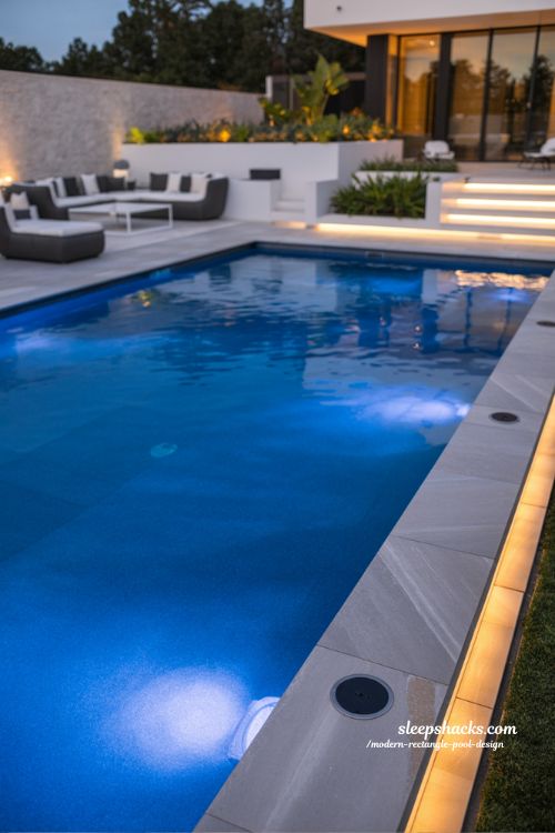 Modern rectangle pool with smart automation LED lighting and luxury backyard technology design ideas