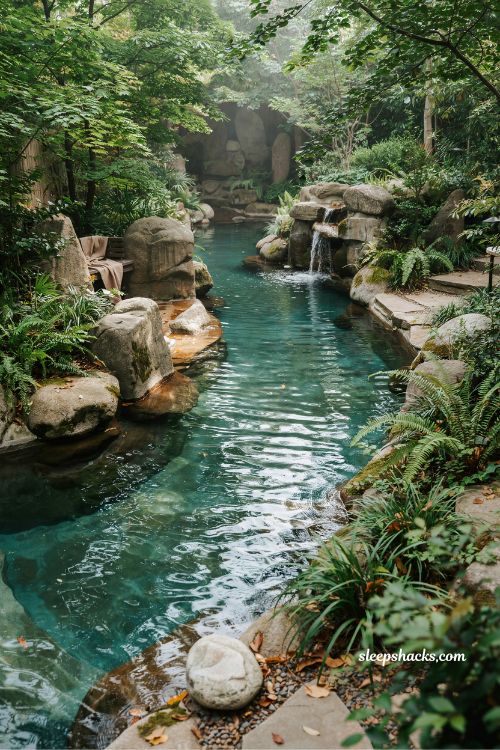 Naturalistic lazy river with rock formations and waterfalls backyard tropical stream design ideas