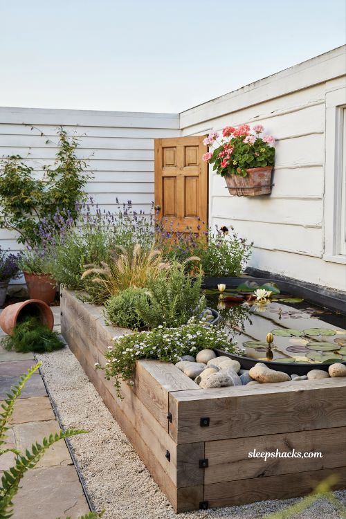 Pond form raised garden bed idea with lavender herbs and compact backyard design