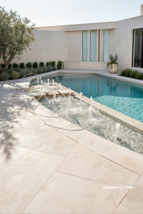 Pool with bubblers and deck jets modern backyard design interactive water features luxury family swimming pool with arcing water streams and shallow ledge