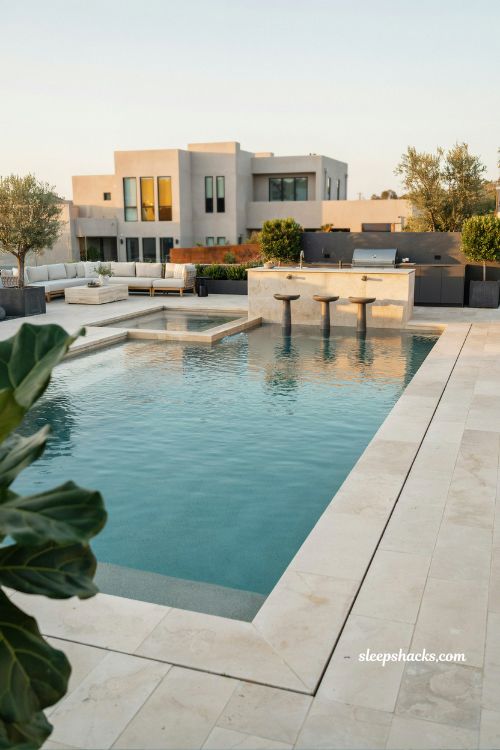 Pool with swim up bar modern backyard luxury design entertaining outdoor kitchen inground pool with submerged seating and resort style social space