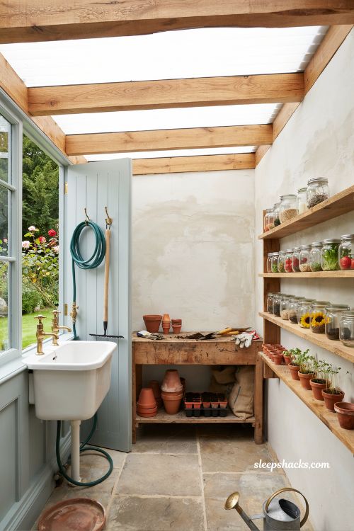 Potting shed for gardeners with sink bench storage and natural garden workspace