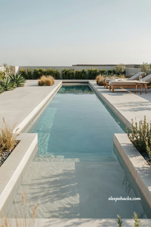 Rectangular lap pool backyard design with modern resort style landscaping