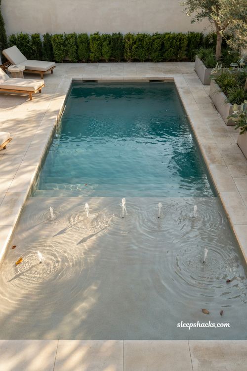 Rectangular pool shallow tanning ledge with bubbler jets design idea