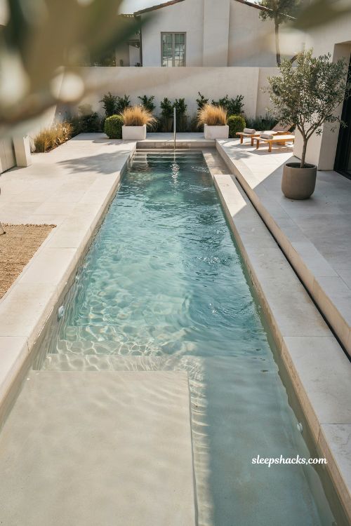 Rectangular pool swim up bench facing sun shelf design idea