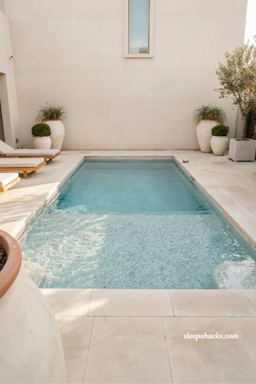 Rectangular pool with soft pearl white pebble interior finish design idea