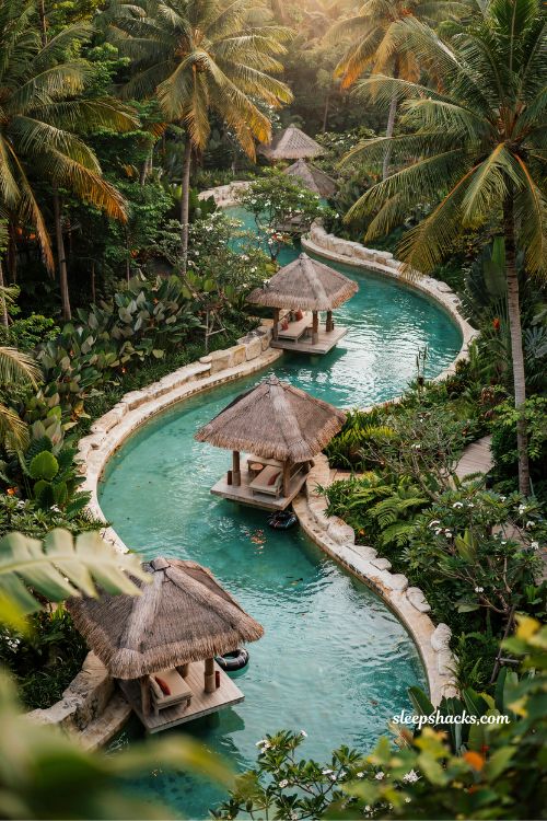 Resort style lazy river with thatched roof rest stops tropical backyard design ideas