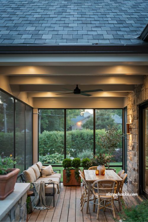 Screened in deck with roof, ceiling fan and warm evening lighting design